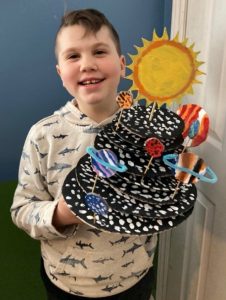 Malcolm holding a model of the Solar System he created.
